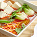 A bowl of Lee Kum Kee Sichuan-style hot and spicy soup with vegetables and tofu.