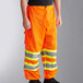 Ergodyne GloWear 8911 orange safety pants with yellow reflective stripes.