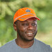 A man wearing an orange Ergodyne high visibility baseball cap.
