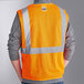 A person wearing an orange Ergodyne GloWear reflective safety vest.