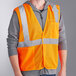 A man wearing an Ergodyne orange reflective mesh vest.