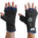 A pair of blue and black Ergodyne ProFlex thermal fingerless work gloves with blue wrists.