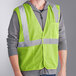 A man wearing an Ergodyne high visibility lime mesh vest.