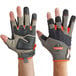 A close-up of a pair of Ergodyne ProFlex heavy-duty framing gloves with orange and black accents.