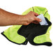 A hand putting a piece of paper in an Ergodyne N-Ferno hand warming pack.