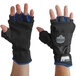 A pair of black and blue Ergodyne ProFlex thermal fingerless work gloves with blue wrist cuffs.