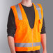 An Ergodyne orange high visibility surveyor vest with reflective stripes.