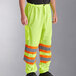 A person wearing Ergodyne lime yellow and orange reflective safety pants.