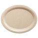 A beige oval platter with a speckled rim.