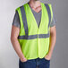 A person wearing a lime Ergodyne safety vest.