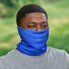 A man wearing a blue Ergodyne Chill-Its multi-band face covering over his face.