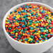 A bowl of Bold Confetti Sequin Sprinkles in various colors.