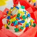A cupcake with Rainbow Alphabet Sprinkles on top.