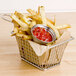 A basket of french fries with a bowl of ketchup.