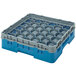 A teal plastic Cambro glass rack with clear glass compartments inside.