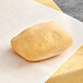 A Schar gluten-free ciabatta roll on a piece of paper.