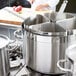 A Vollrath stainless steel pasta insert set in a large pot.