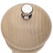 A close-up of a Chef Specialties Windsor Natural Maple pepper mill with a silver knob.