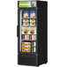 A Turbo Air black swing door freezer with LED advertising panel full of food.
