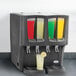 A Crathco refrigerated beverage dispenser with four different drinks.