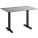 A Lancaster Table & Seating rectangular dining table with a textured metal top and black metal legs.