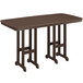 A POLYWOOD mahogany bar height table with two legs on an outdoor patio.