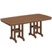 A teak POLYWOOD dining table on an outdoor patio.