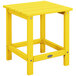A POLYWOOD lemon yellow side table on a wooden outdoor patio.