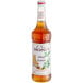 A bottle of Monin Premium Honey Jasmine flavoring syrup with a white label.