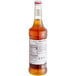 A bottle of Monin Honey Jasmine Syrup with a white label.