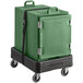 A green CaterGator front loading food pan carrier on a black dolly with straps.