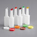 A group of white Choice plastic pour bottles with assorted flip tops and caps.