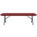 A red rectangular Correll folding table with black legs.