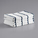 A stack of Monarch Brands navy and white striped towels.
