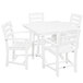 A POLYWOOD white farmhouse dining table with four arm chairs.