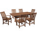 A POLYWOOD teak dining table with six chairs on a outdoor patio.