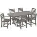 A POLYWOOD slate grey outdoor dining set with a Nautical table and six chairs on an outdoor patio.
