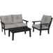 A black and grey POLYWOOD outdoor seating set with a grey couch and chair and a black table.