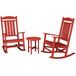 A red POLYWOOD rocking chair and table set.