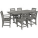 A POLYWOOD slate grey rectangular dining table with six chairs on an outdoor patio.