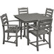 A POLYWOOD La Casa Cafe farmhouse trestle outdoor dining set in slate grey with four arm chairs.