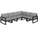 A black and grey POLYWOOD sectional couch with four cushions.