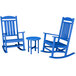 A POLYWOOD blue rocking chair and table set.