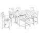 A POLYWOOD white table with a white Nautical Trestle table and six white chairs.