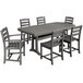 A POLYWOOD slate grey dining table with six chairs on an outdoor patio.