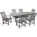 A POLYWOOD outdoor dining table with a white top and six chairs on an outdoor patio.