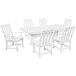 A white POLYWOOD dining table with a white background and six white chairs.