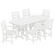A POLYWOOD white dining table with six white chairs.