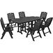 A POLYWOOD black outdoor dining set with a table and six folding chairs.