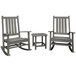 A group of grey POLYWOOD Vineyard rocking chairs with a table.